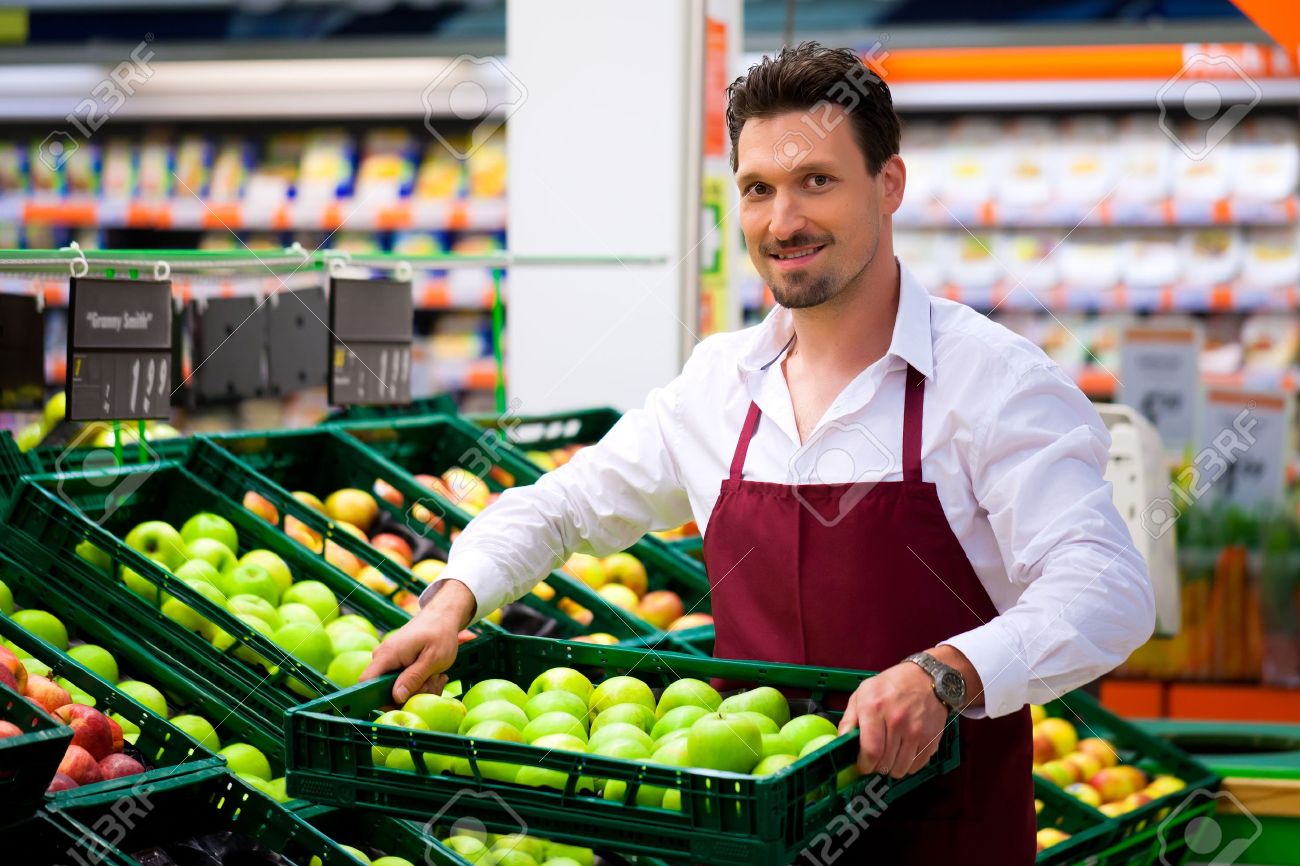 10041188-man-in-supermarket-as-shop-assistant-he-brings-some-boxes-with-apples.jpg
