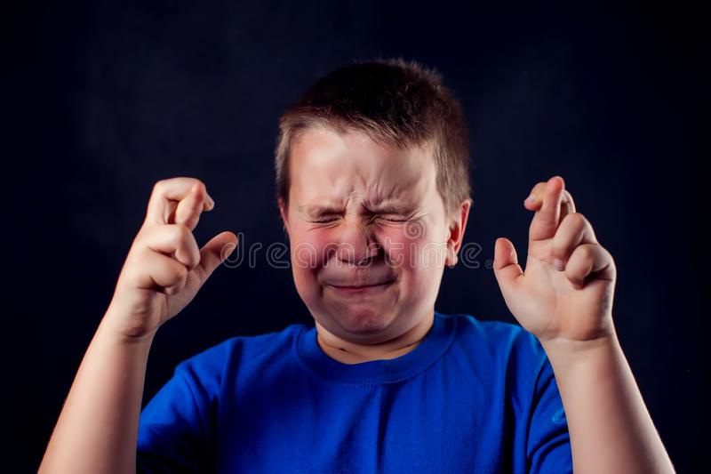 portrait-boy-crossed-fingers-front-dark-background-children-emotions-concept-cute-160765006.jpg