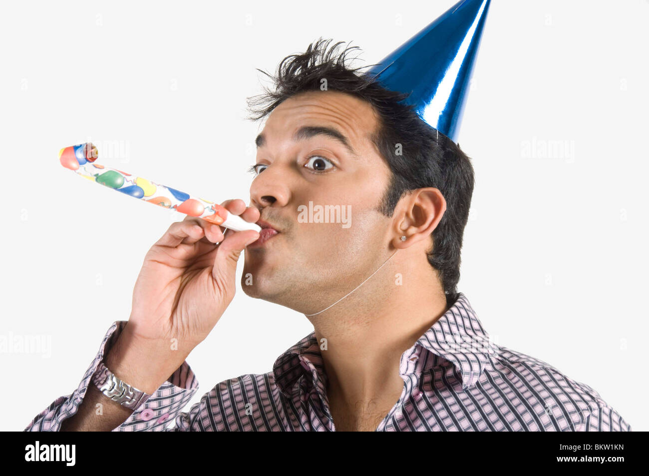 young-man-blowing-party-horn-blower-close-up-BKW1KN.jpg